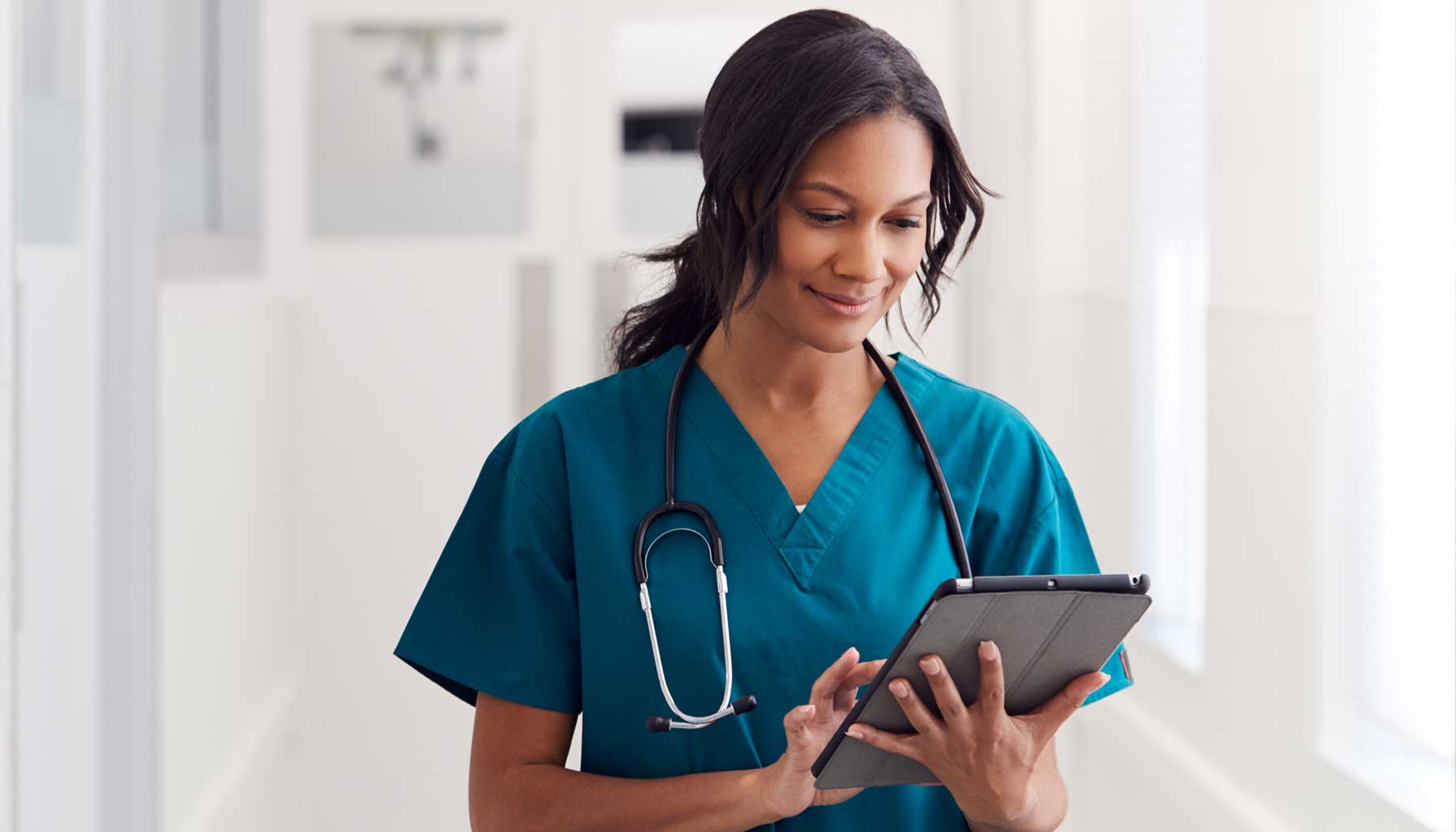 A busy Black doctor walks down a bright, white corridor in a medical facility. Her hair, slightly disheveled, tells us she’s been working hard. She scrolls her tablet with one finger and unconsciously smiles—having just read referral-source marketing that offers a solution to a clinical challenge.