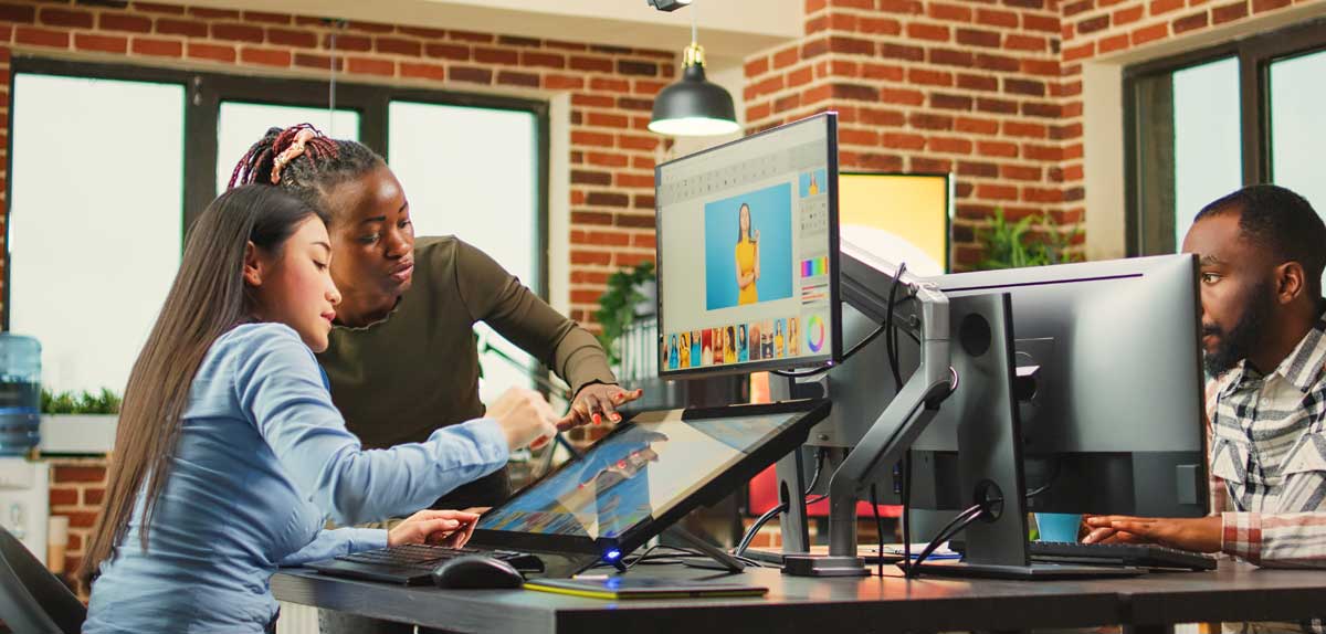 Creative professionals using computers to produce a video.